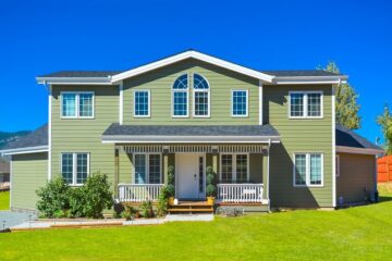 sage green house with white and green trim